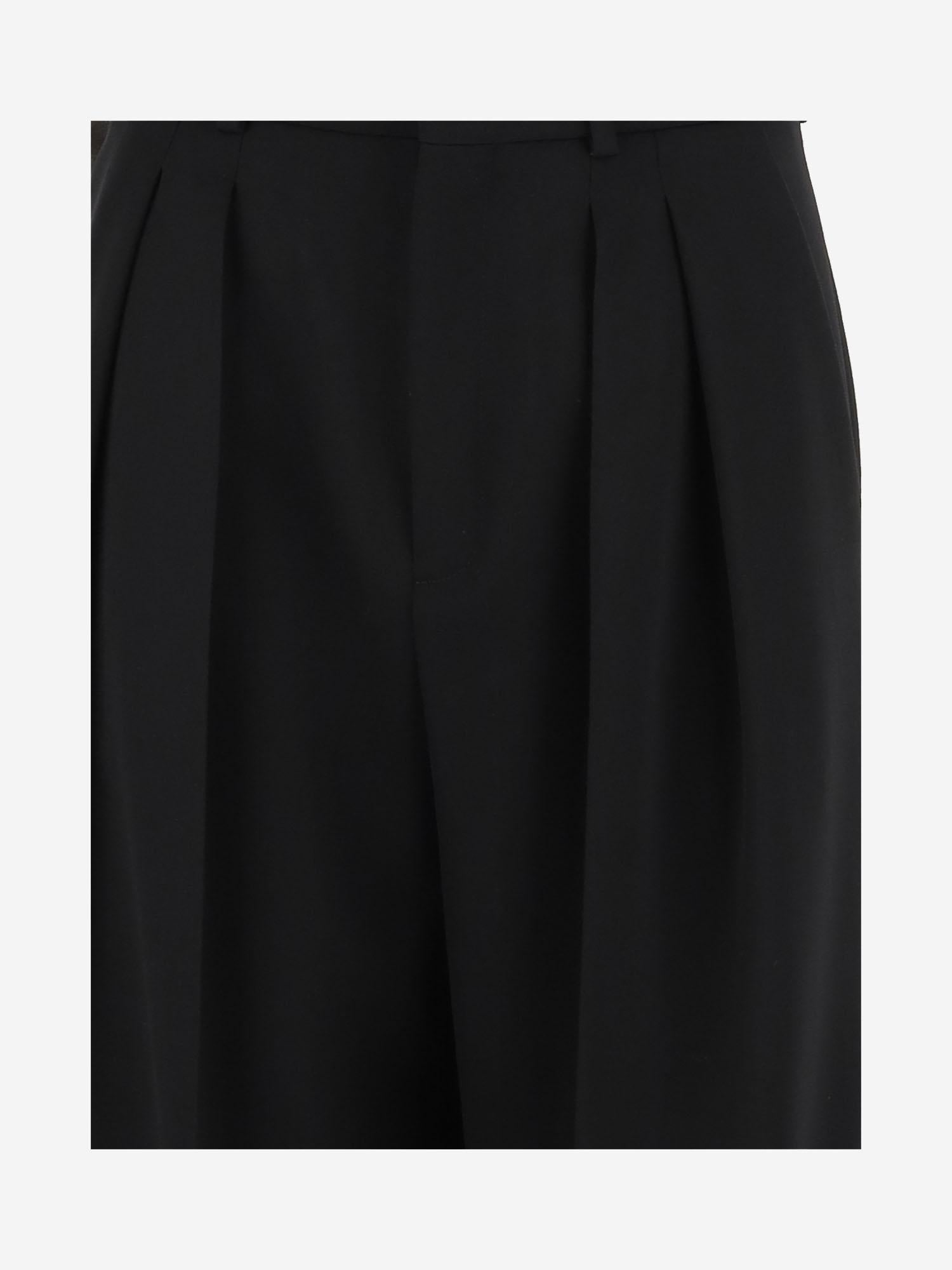 Pantaloni sartoriali a vita alta e gamba ampia in lana 824389 Y7E631000 SAINT LAURENT