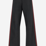 Pantaloni in denim di cotone stretch spalmato con nastro web A006GG XDDH31000 GUCCI 