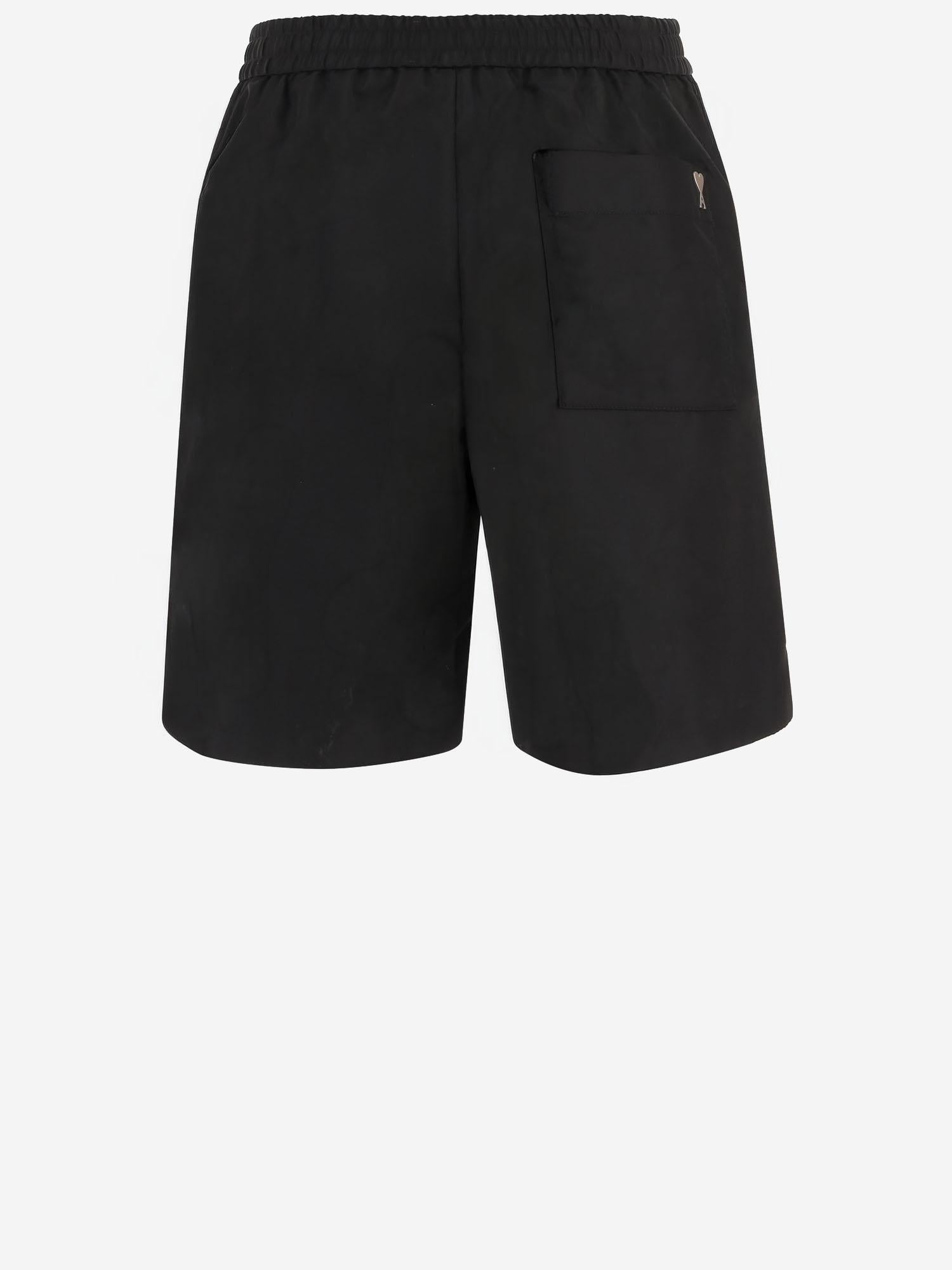 PANTALONI CORTI IN NYLON HSO833PA0037 001 AMI 